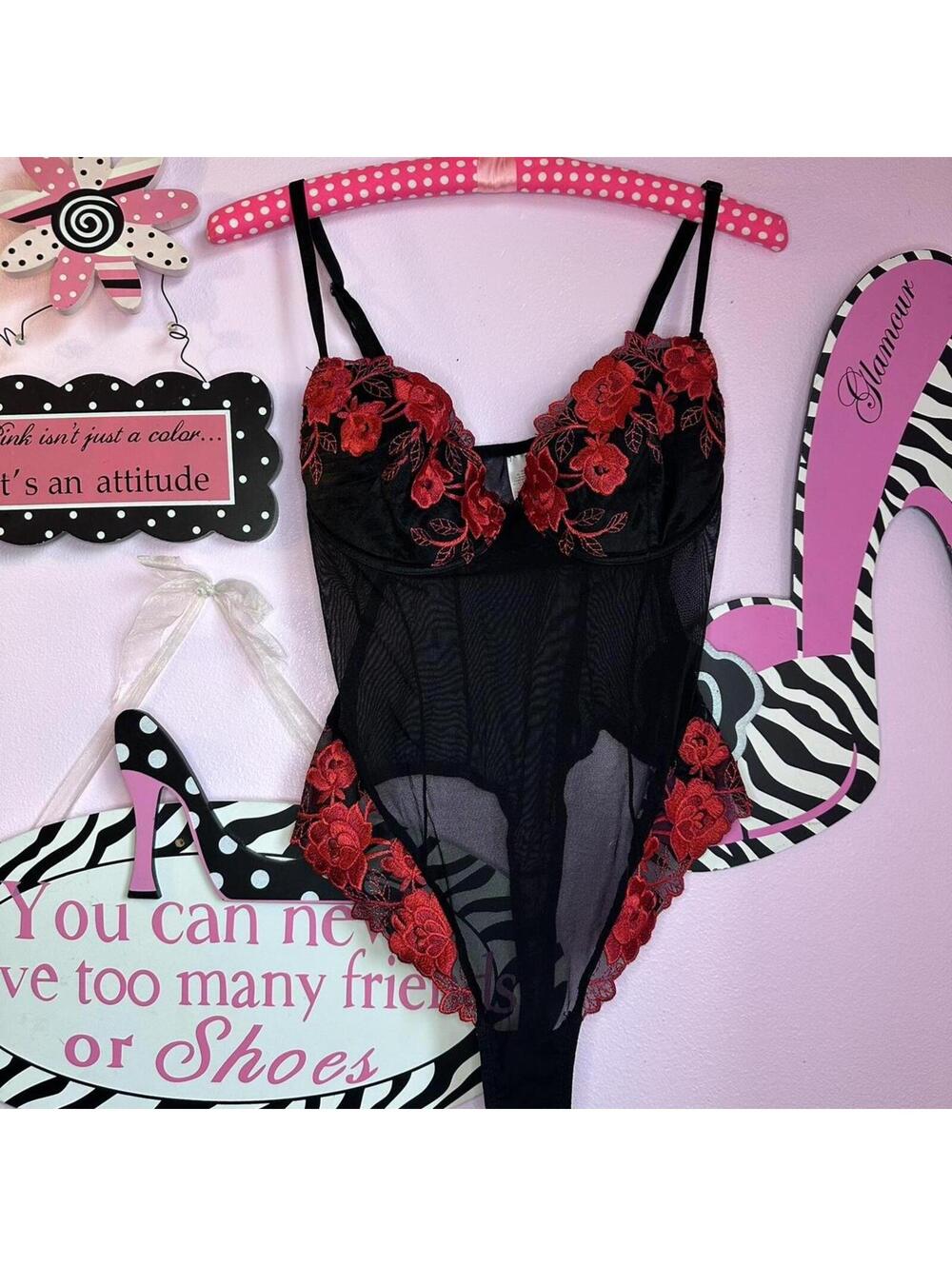 Black mesh lingerie bodysuit with bold red floral embroidery